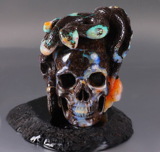 This is a Matrix Opal skull and snakes in Black Onyx stand. Its 3.4 